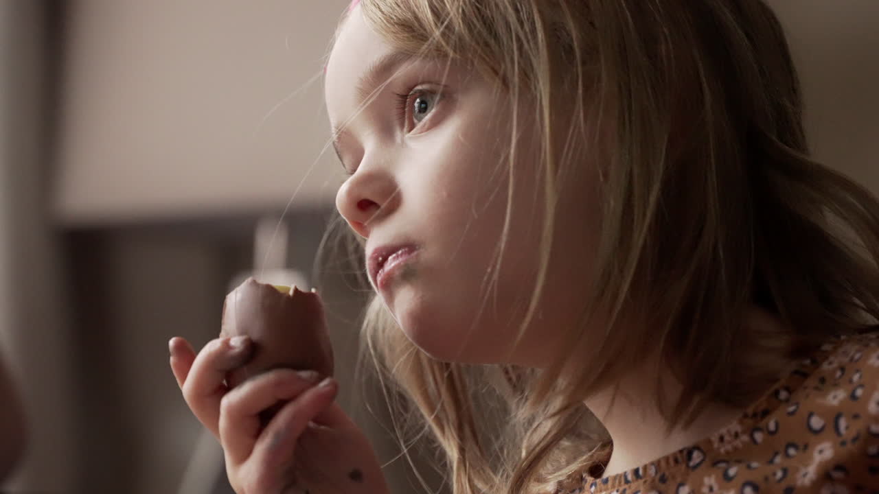 Little girl enjoying a tasty chocolate treat at Easter