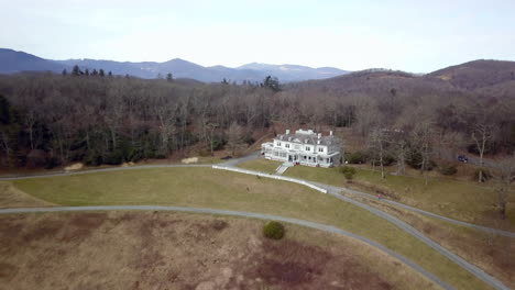 aerial shot pulling out from moses cone manor on the moses cone estate near blowing rock north carolina