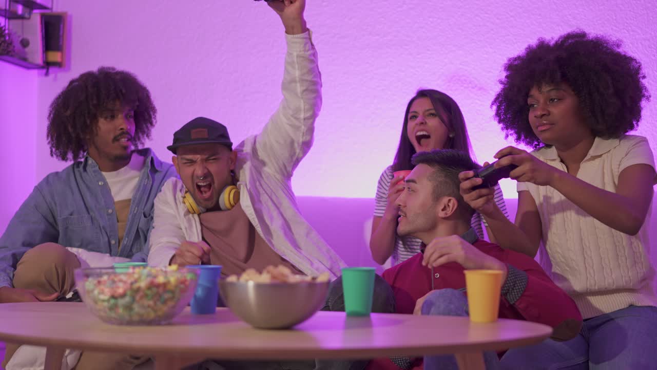 Diverse friends enjoy a lively video game night at home with snacks