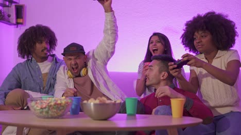 diverse friends enjoy a lively video game night at home with snacks
