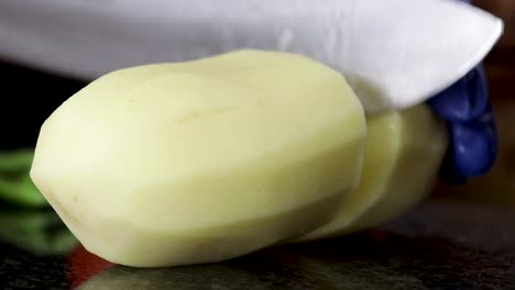 Close-up-of-peeled-potato-being-cut-up-into-chunks