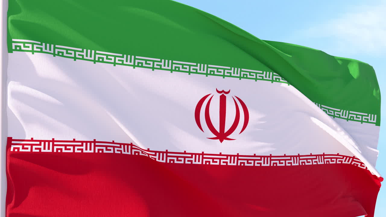The National Flag of Iran Waving in the Wind Against a Blue Sky