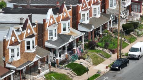 rundown row houses with american flag on porch