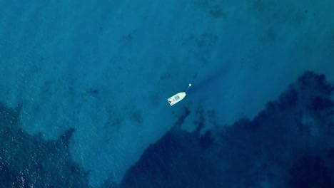 Skyview-of-a-sailboat-in-Blue-Lagoon,-Punta-Molentis-Beach,-Villasimius,-South-Sardinia,-Italy