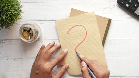 high angle view of question mark on paper on office desk