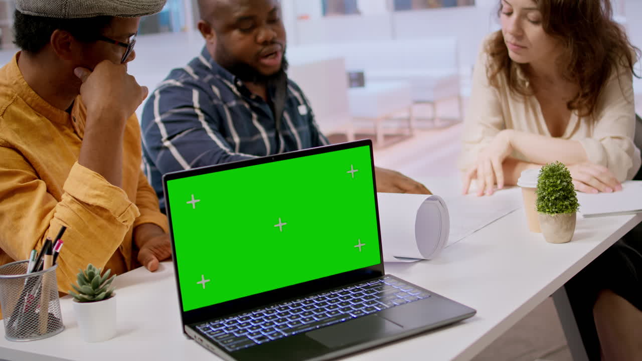 Contractors team showing office space sketch next to isolated chroma key