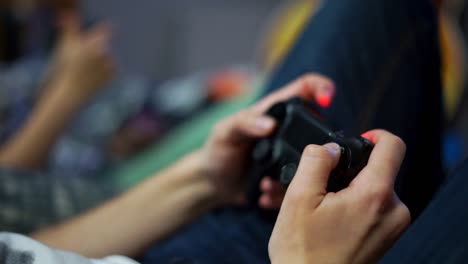 Close-Up-view-of-woman's-hands-playing-video-game-at-home.-Shooting-and-controlling-using-the-game-controller.-Wireless-game