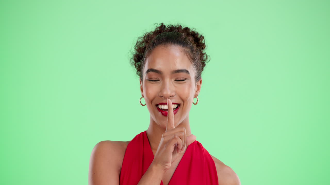 A woman holding a finger to her lips