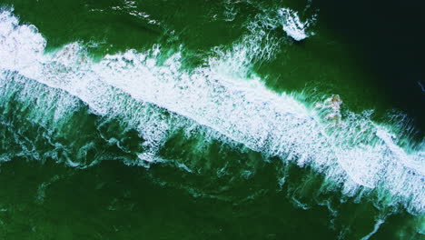 aerial descending from 400 feet over ocean wave patterns and textures