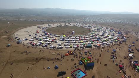 aerial drone shot of naadam festival mongolia dozen of yurts sunny day