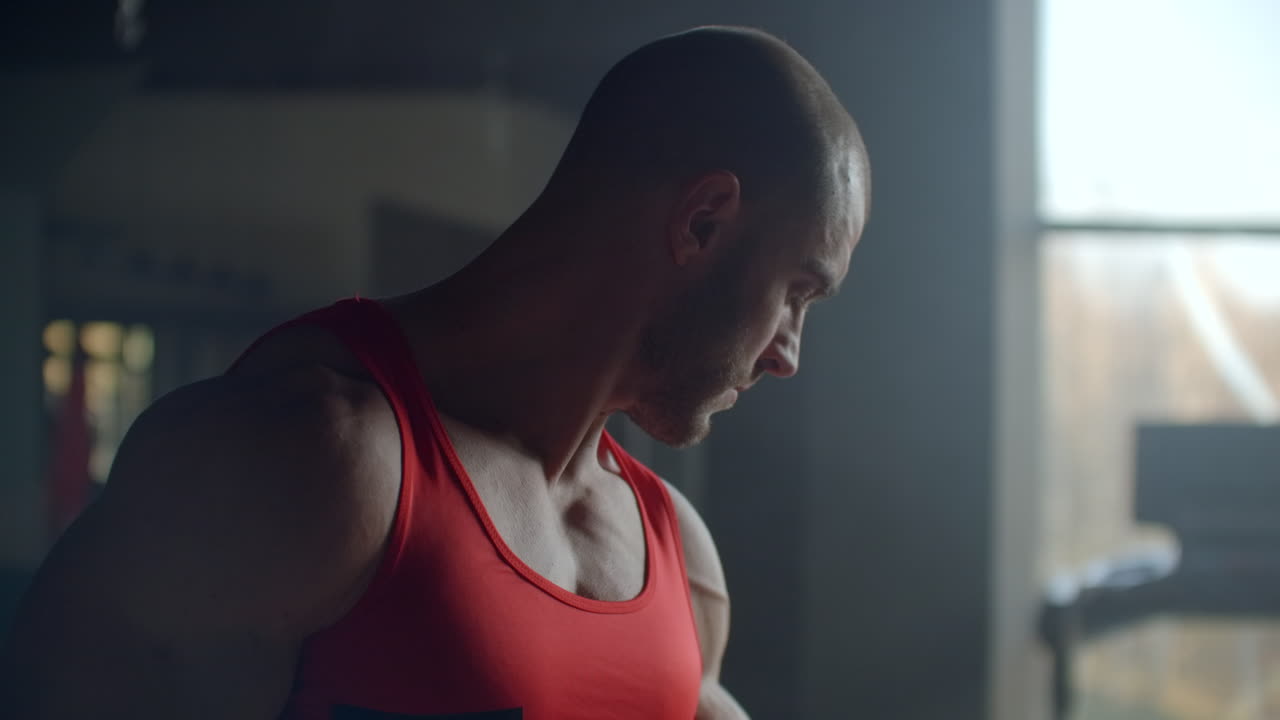 An athlete lifts weights to train your biceps in the gym. Strength training to build muscle. Hard and hard training for strong hands. Slow motion professional bodybuilder