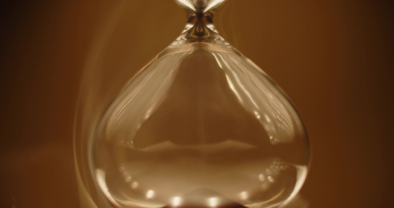 Smoke slowly wraps an hourglass
