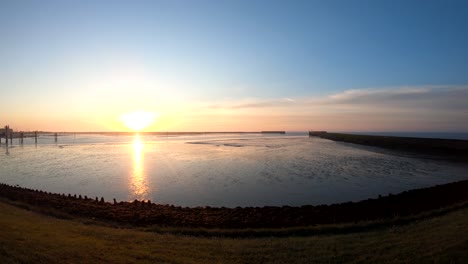 aerial drone footage bird's eye view at the sunrise by the ocean going from left to right