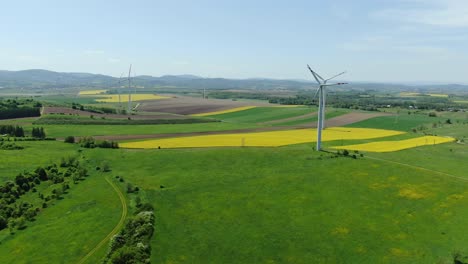 Wind-turbines-on-fields-produce-renewable-energy,-modern-power-plants-in-rural-Europe