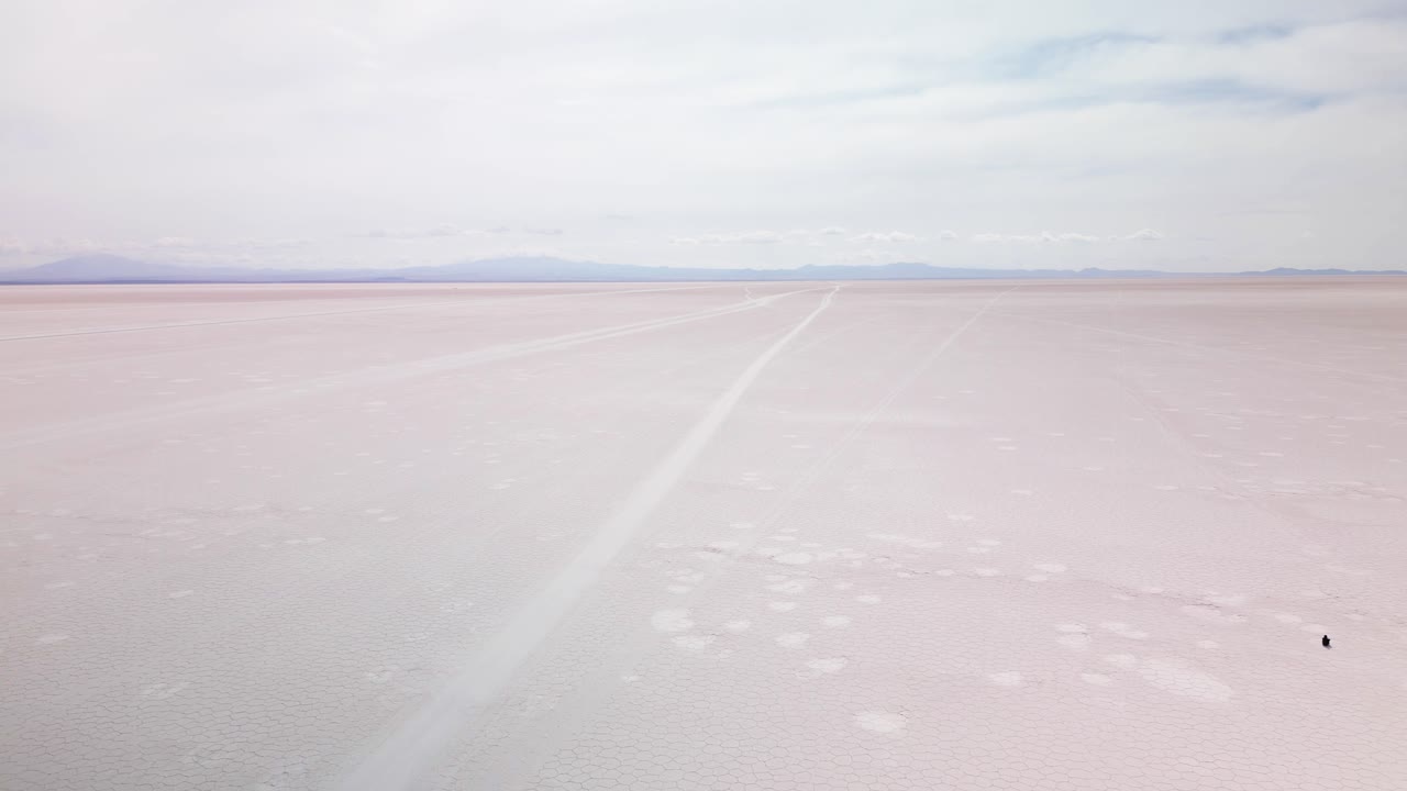 People At Salar de Uyuni Amidst Andes In Southwest Bolivia, South America. Aerial Shot