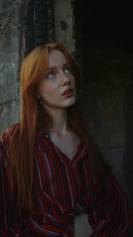 young woman in striped shirt at a ruined building