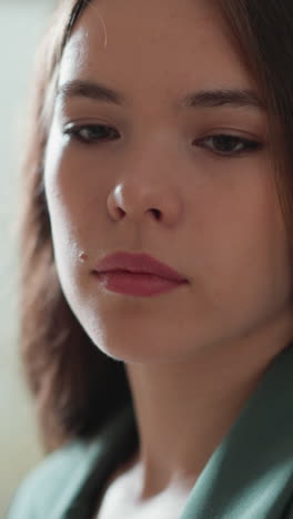 woman feels sorrows on light background closeup. thoughtful businesswoman suffers from harassment at workplace. office employee exhausted problems