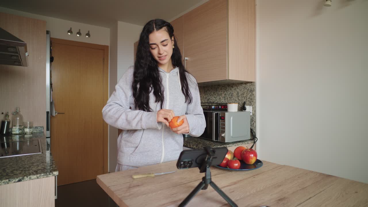 A woman preparing fruit in her kitchen