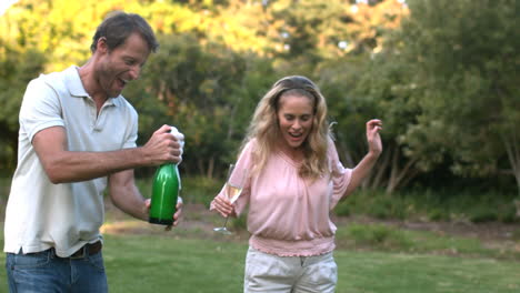 man shaking a bottle of champagne