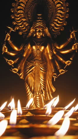 golden statue of durga with diyas