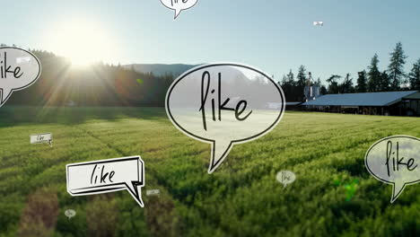 animation of like text on multiple speech bubbles floating against aerial view of grassland