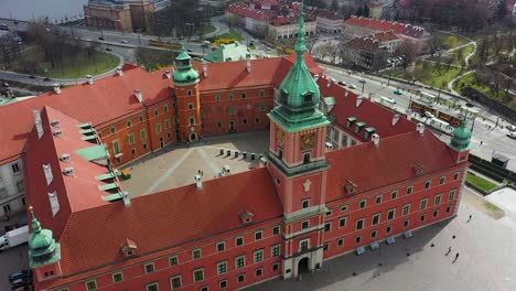 Aerial-view-rising-away-from-the-bell-tower-of-the-Royal-castle-in-Warsaw,-Poland---pull-back,-drone-shot