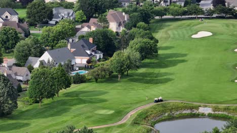 luxury residential area in suburb of american town. mansion and villas with swimming pool and private golf course in garden. rich and wealthy district. aerial wide shot