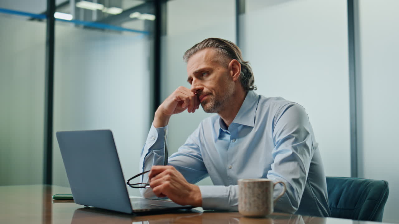 Worried ceo sitting workplace closeup. Stressed businessman getting bad news