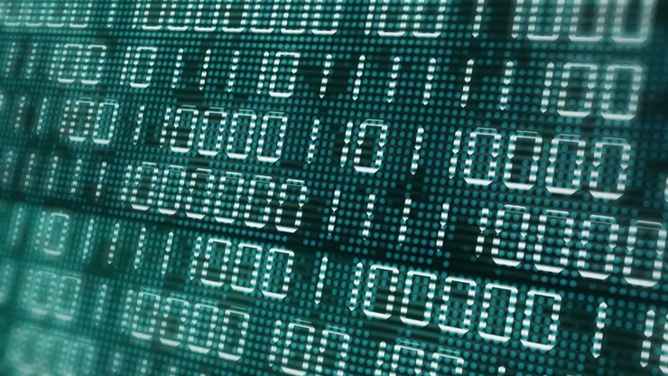 Electronic close up screen with changing binary code. Green computer display with flickering dots and pixels. Illumination of ones and zeros. Abstract animation with blurred background.