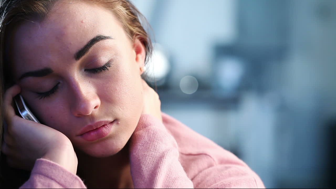 Sad depressed teenage girl using cell phone