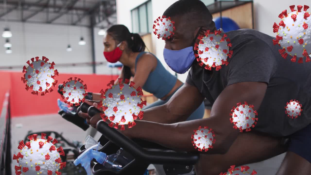 코로나19 세포가 다양한 그룹 위에 떠다니고 마스크를 쓰고 운동하는 애니메이션