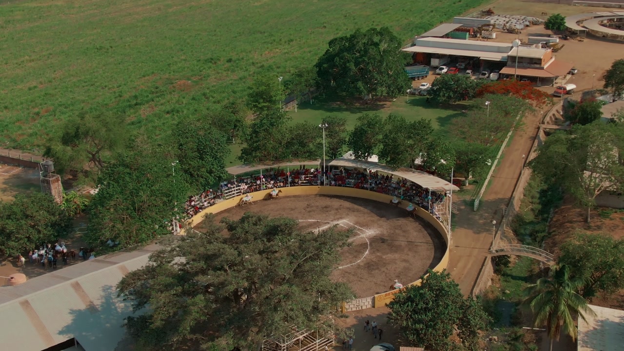 Scaramuza event in Colima, Mexico. Aerial dolly in approaching circular arena during rodeo cultural performance