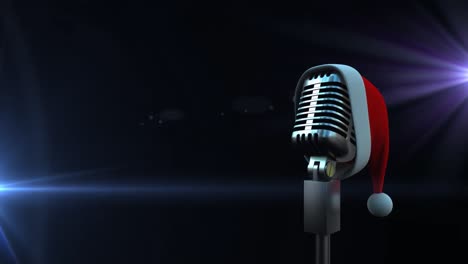 microphone with santa hat against spots of light on black background