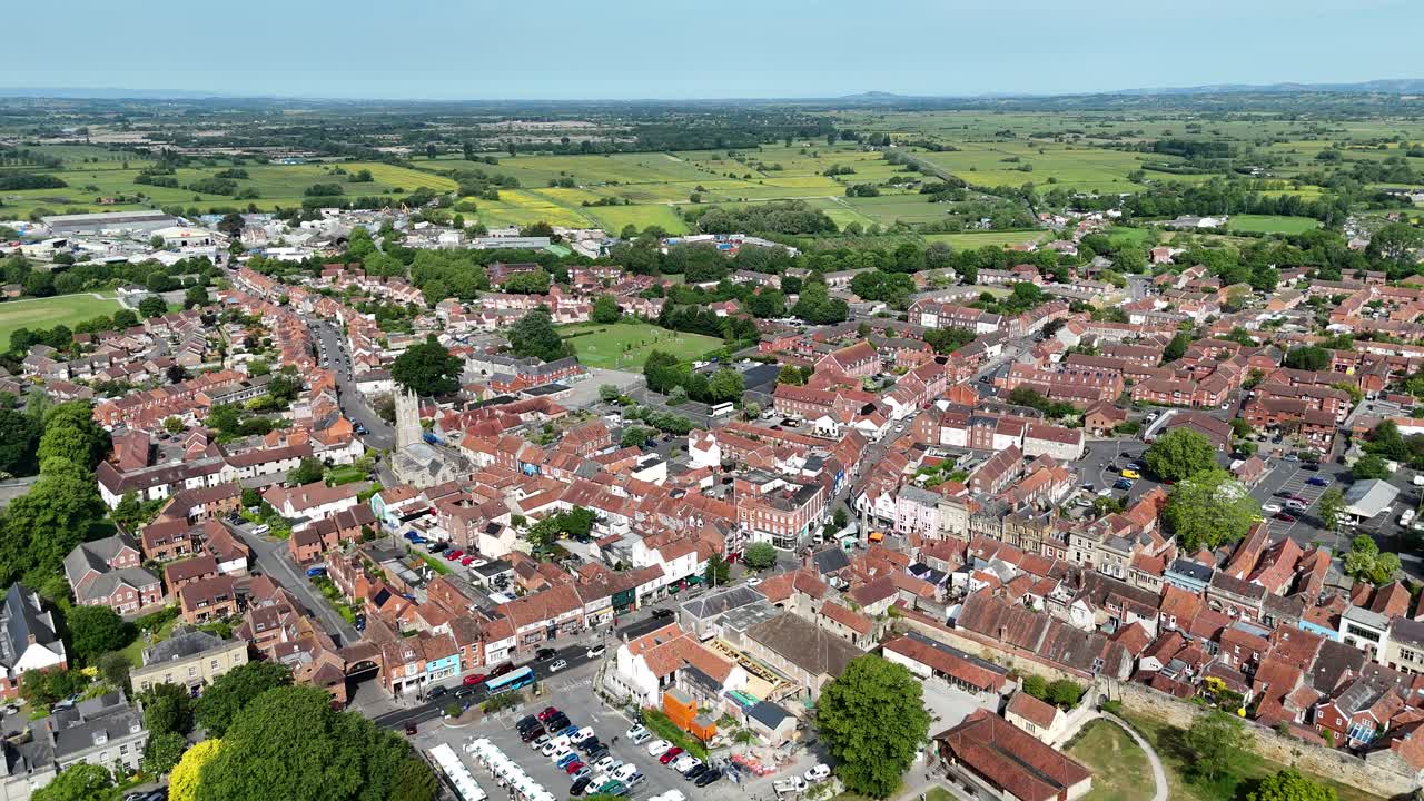 Glastonbury town Somerset UK pull back drone aerial reverse reveal summer