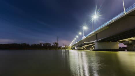 night time lapse of a bridge near water