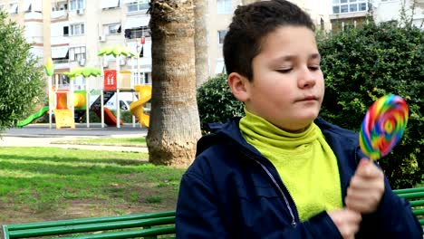 portrait of preteen child eating lollipop