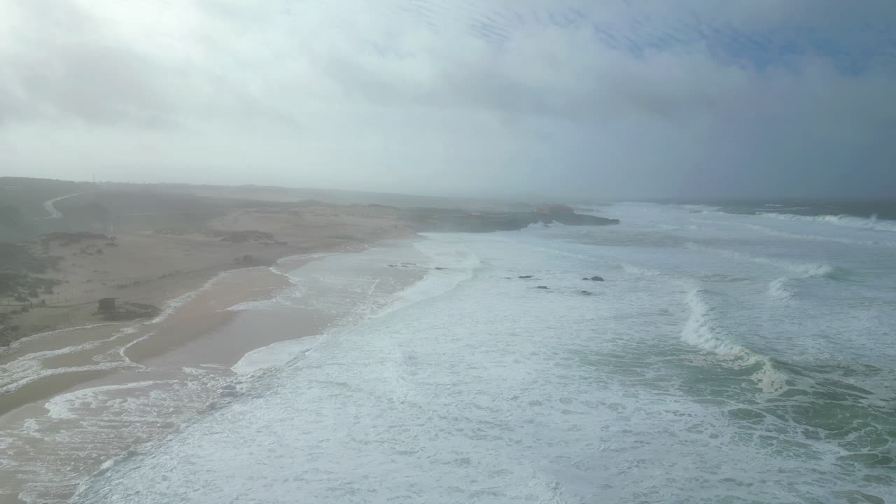 Aerial view of Guincho beach after Storm Kristin, showing the sea white and choppy due to beach erosion. Cascais,Portugal