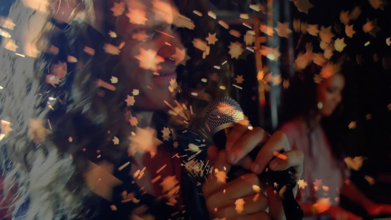 Singer gripping microphone and singing causing leaf particles swirling around revealing pianist