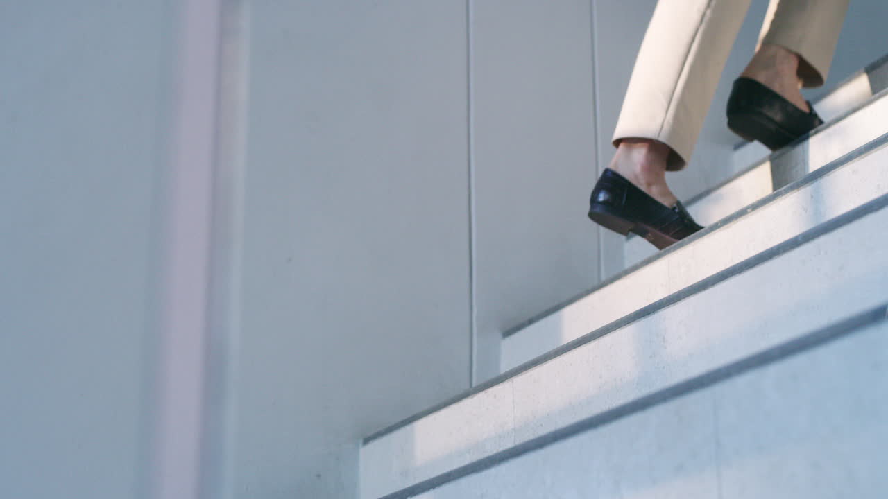 Person walking up the stairs in loafers
