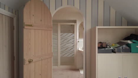 reveal shot of an attic room and en suite in a family home in slow motion