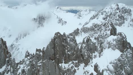 Aerial-View-of-Winter-Scenery-in-Alps,-Snow-Capped-Hills-and-Ridgeline-Above-Innsbruck,-Austria