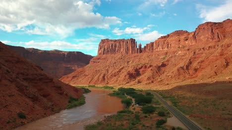 drone shot of the colorado river flowing through a red rock canyon in utah