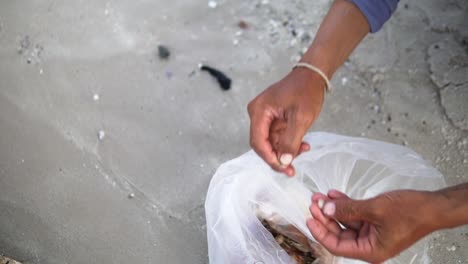 fisherman hands baiting a fishing hook over a sandy beach in hua hin, thailand