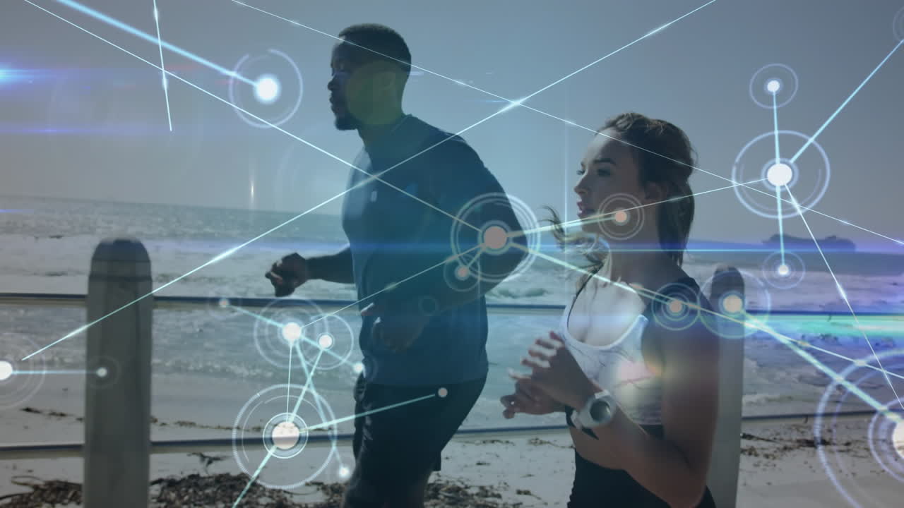 Network of connections against biracial couple running together on the promenade near the beach