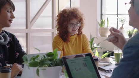 young group of students meeting redhead team leader woman sharing creative ideas enjoying conversation friends discussing business project in modern office workplace