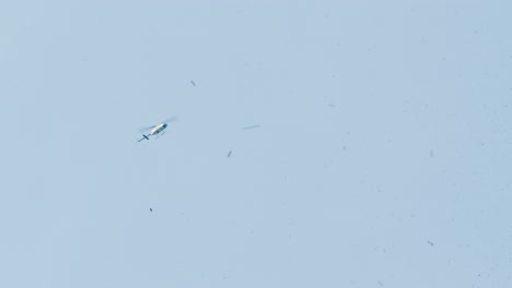 police helicopter hovering over a ticker tape parade in new york city