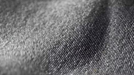 highly detailed grey cloth fabric fluttering on the wind. textile surface with fiber pattern visible in close up camera. natural, smooth drapery movement. endless, seamless, loopable animation.