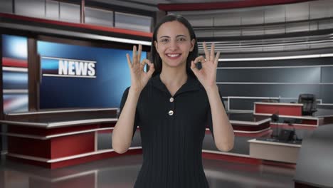 Happy-Indian-female-news-anchor-showing-okay-sign