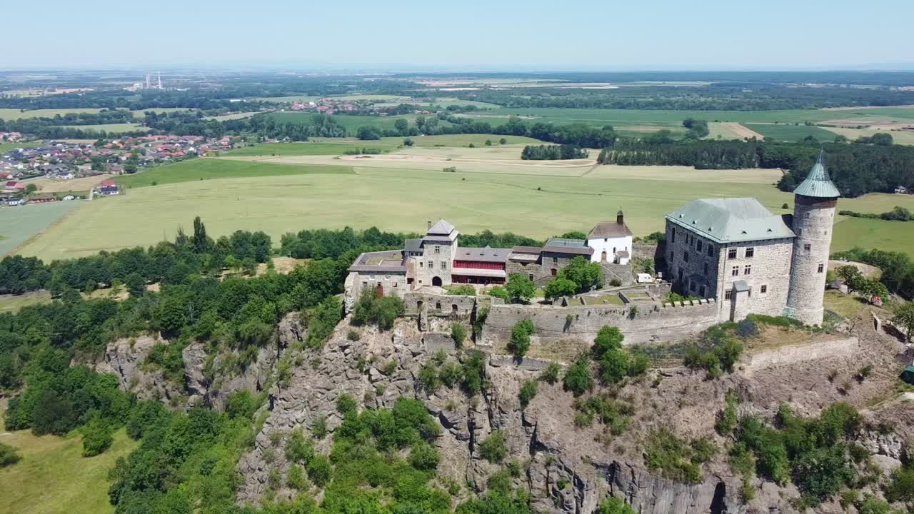 State Castle Kuneticka Hora With Green Fields In The Background In Raby, Czech Republic. - aerial shot