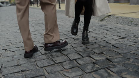 couple legs bouncing on city street. unknown man and woman walking outdoor.